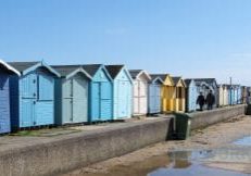 beach huts blue skies